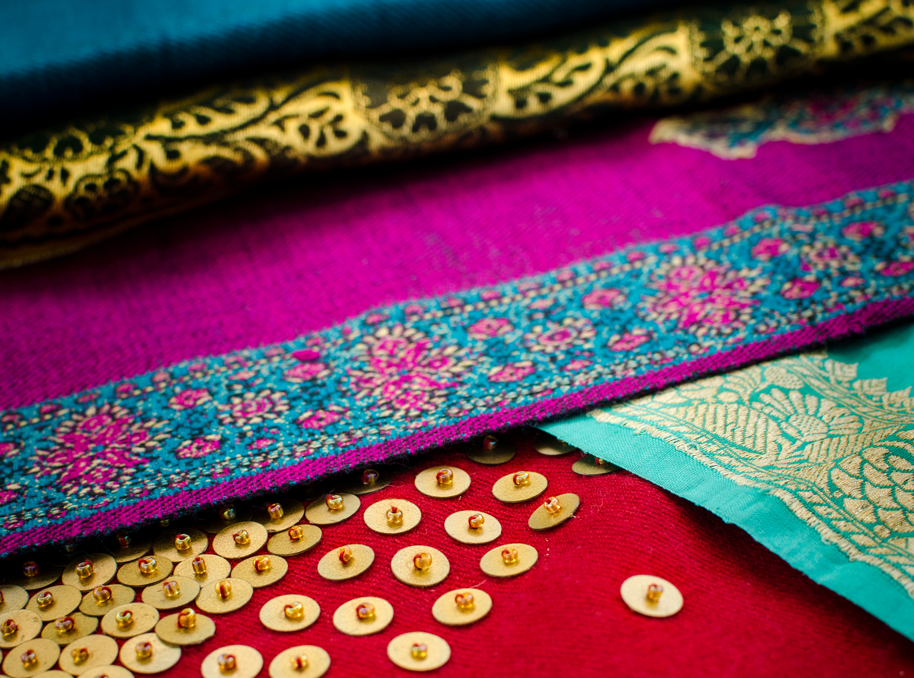 Original photography of colorful Indian sari fabrics for use on Caravale event collateral and presentations